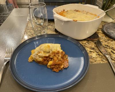 A plated serving of moussaka-style shepherd's pie.